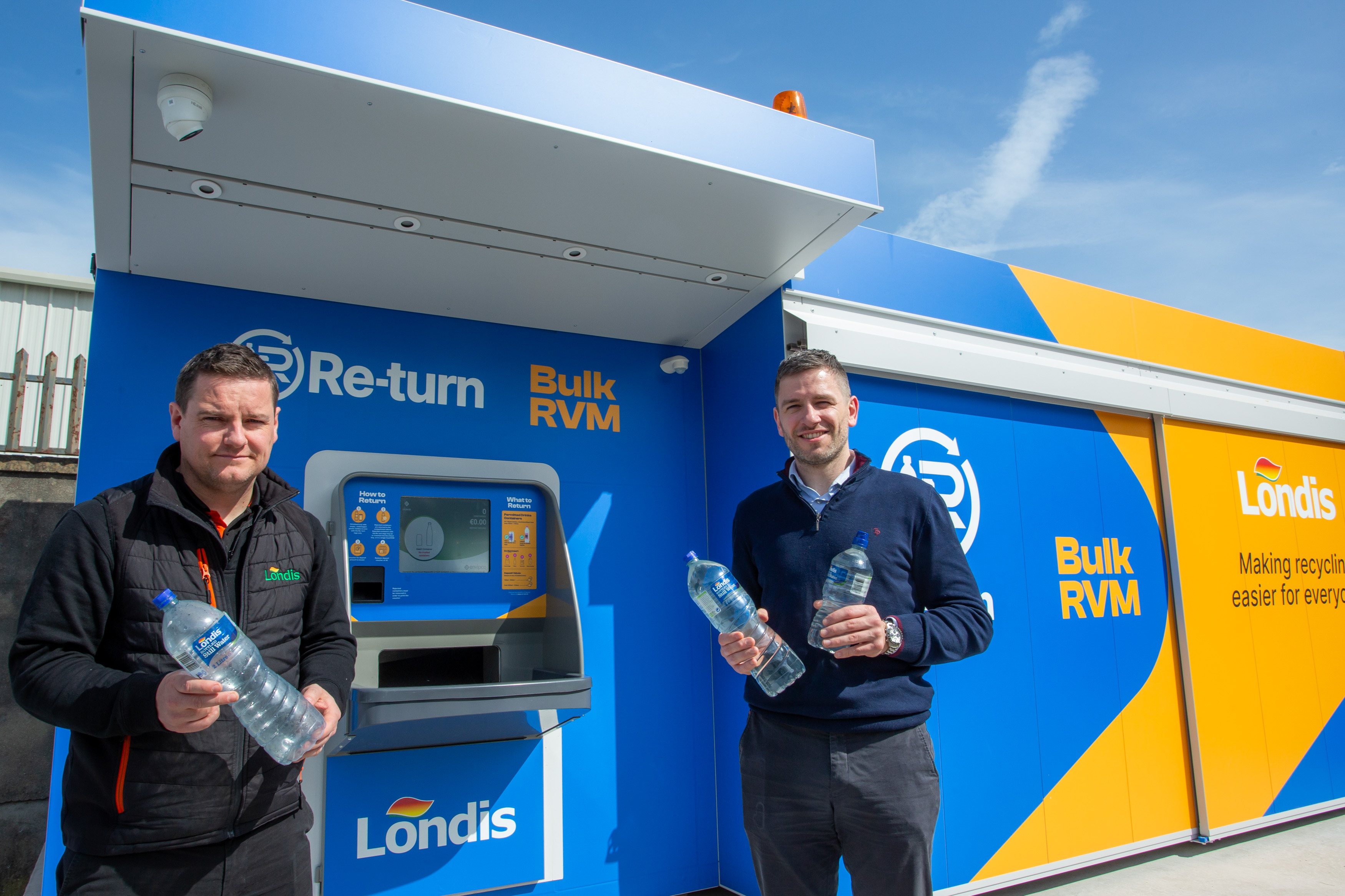 Retailer and store manager showcasing the stores bulk vending machine